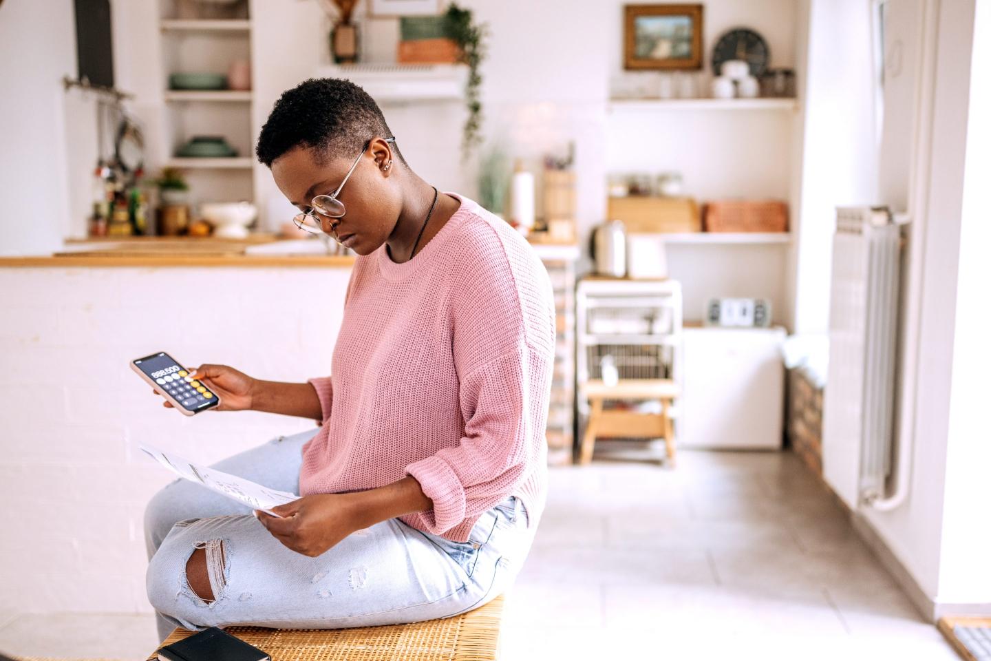 Young woman calculates financial aid package and student loan burden
