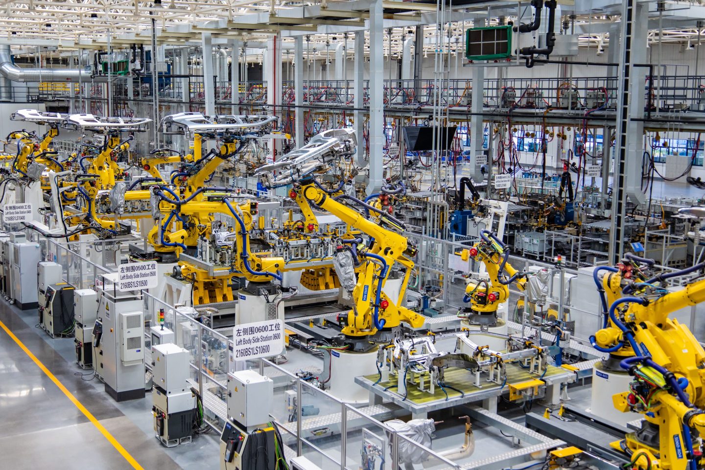 Robotic arms work on the assembly line of electric vehicles at an intelligent factory in Chongqing, China, in August 2022.