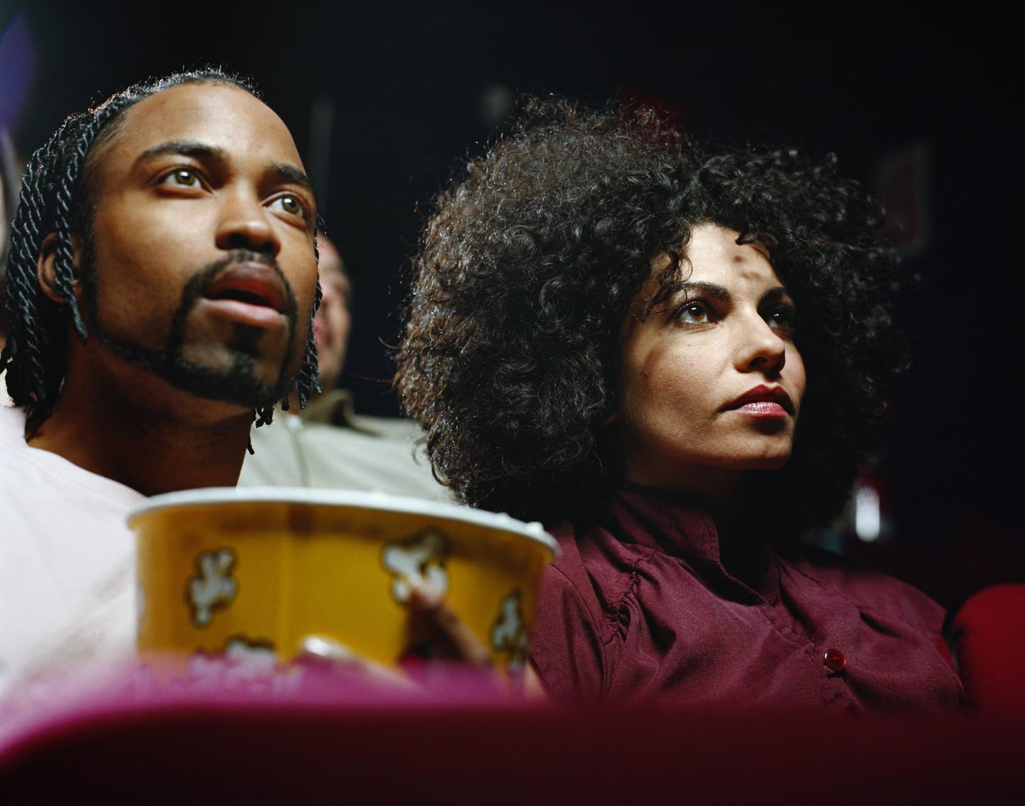 couple watches a movie in a theater