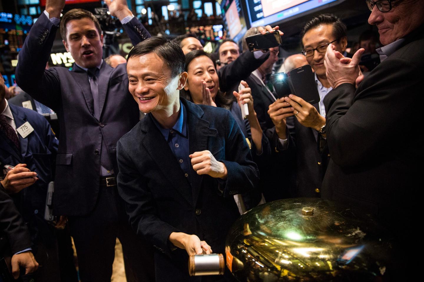 Alibaba founder Jack Ma, surrounded by traders, rings a bell on the floor of the New York Stock Exchange in 2014 to celebrate Alibaba's first day of trading