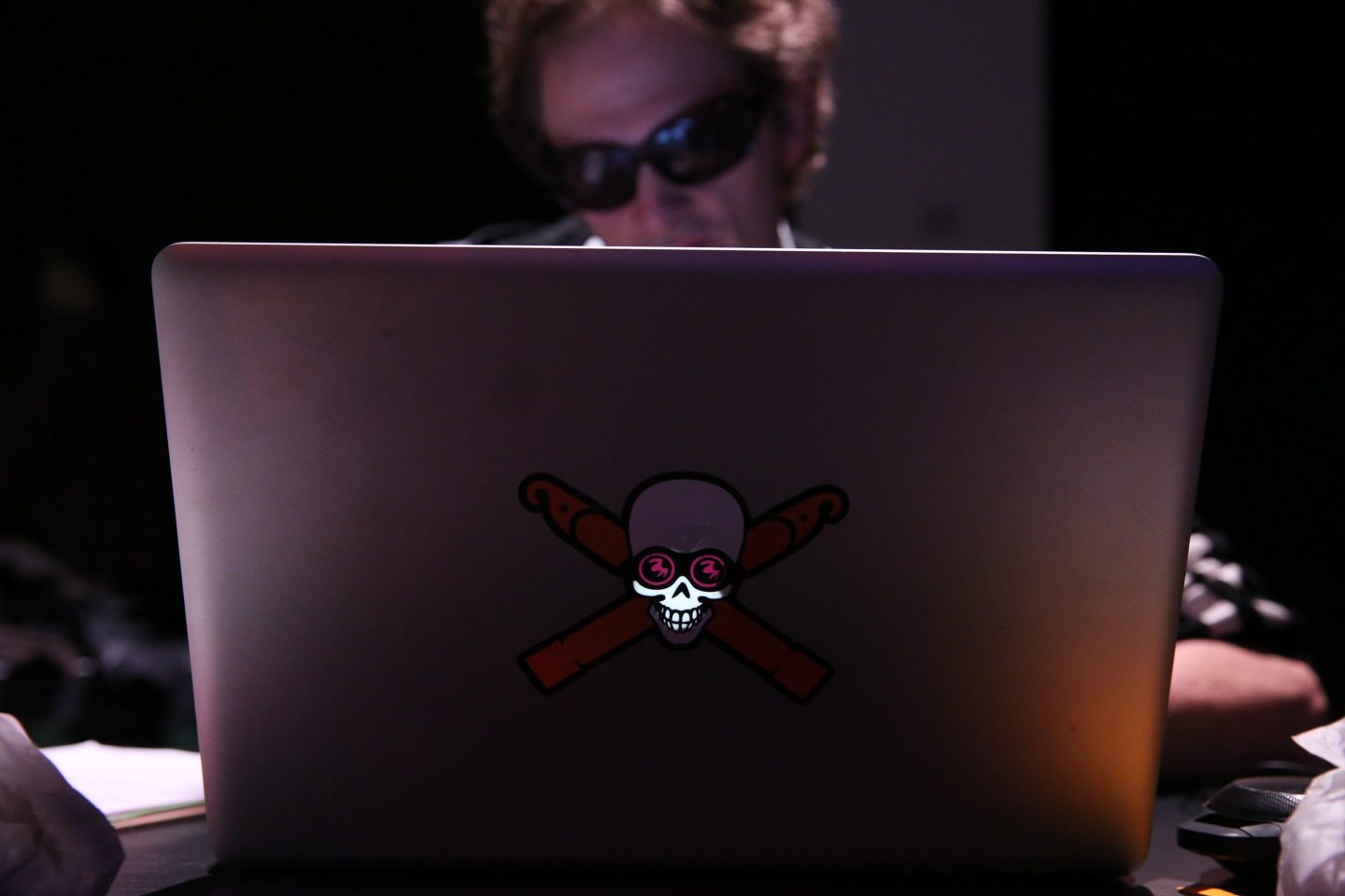 A hacker using a laptop computer at the Hacked By Def Con Press Preview