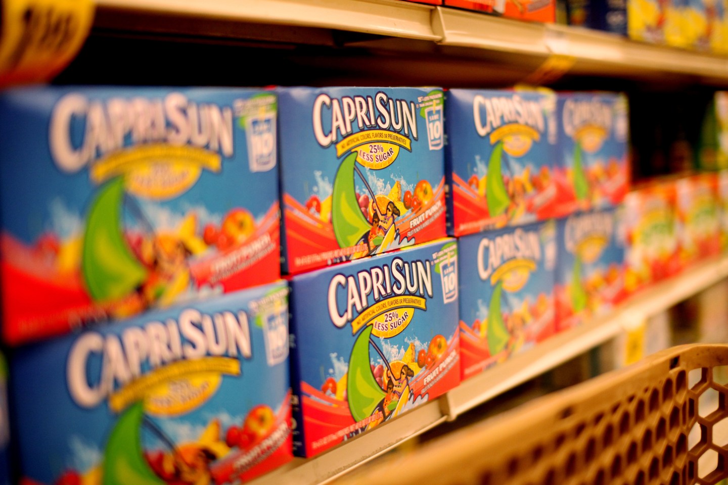Rows of Capri Sun boxes stacked on a supermarket shelf