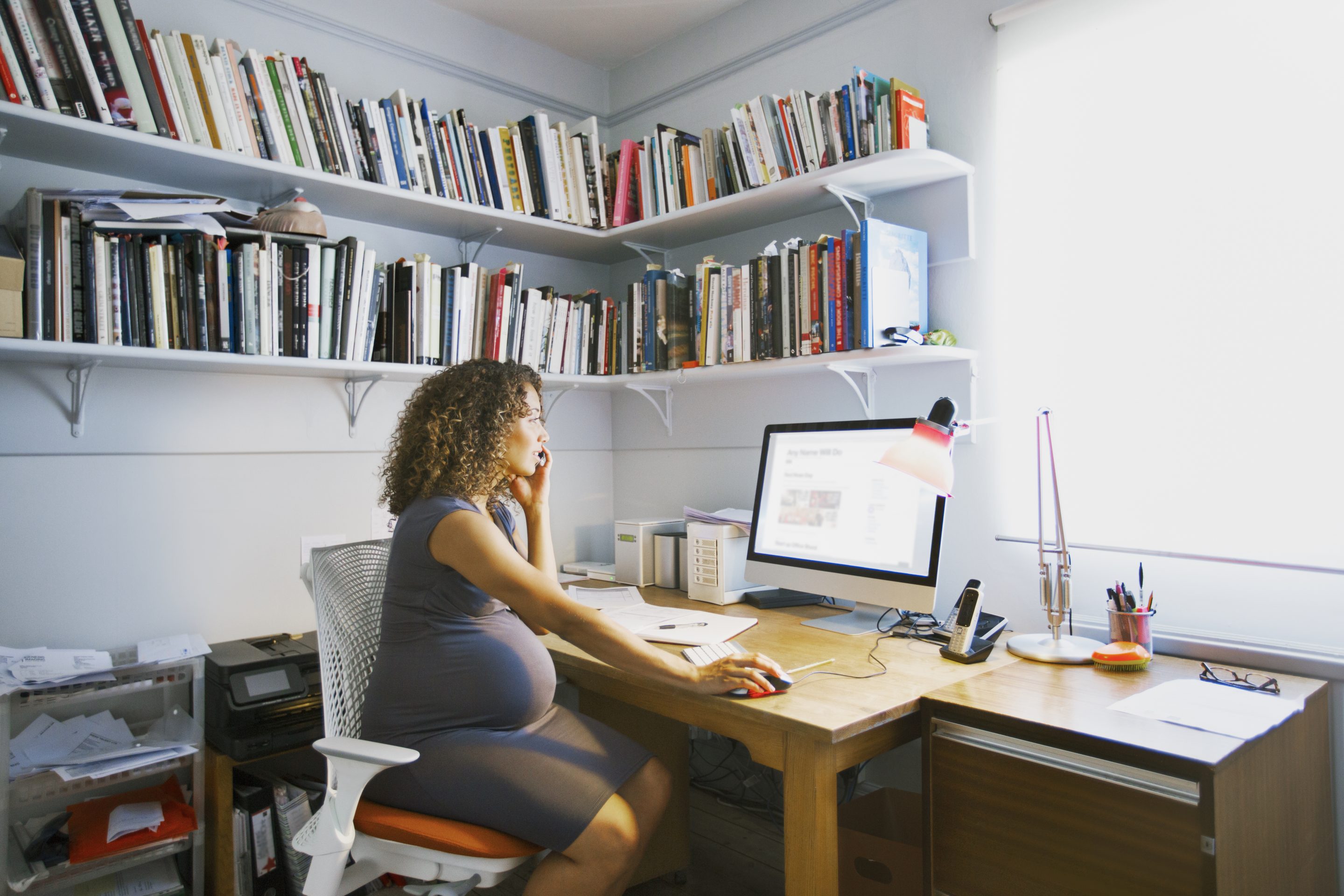 Pregnant lady works from her home office