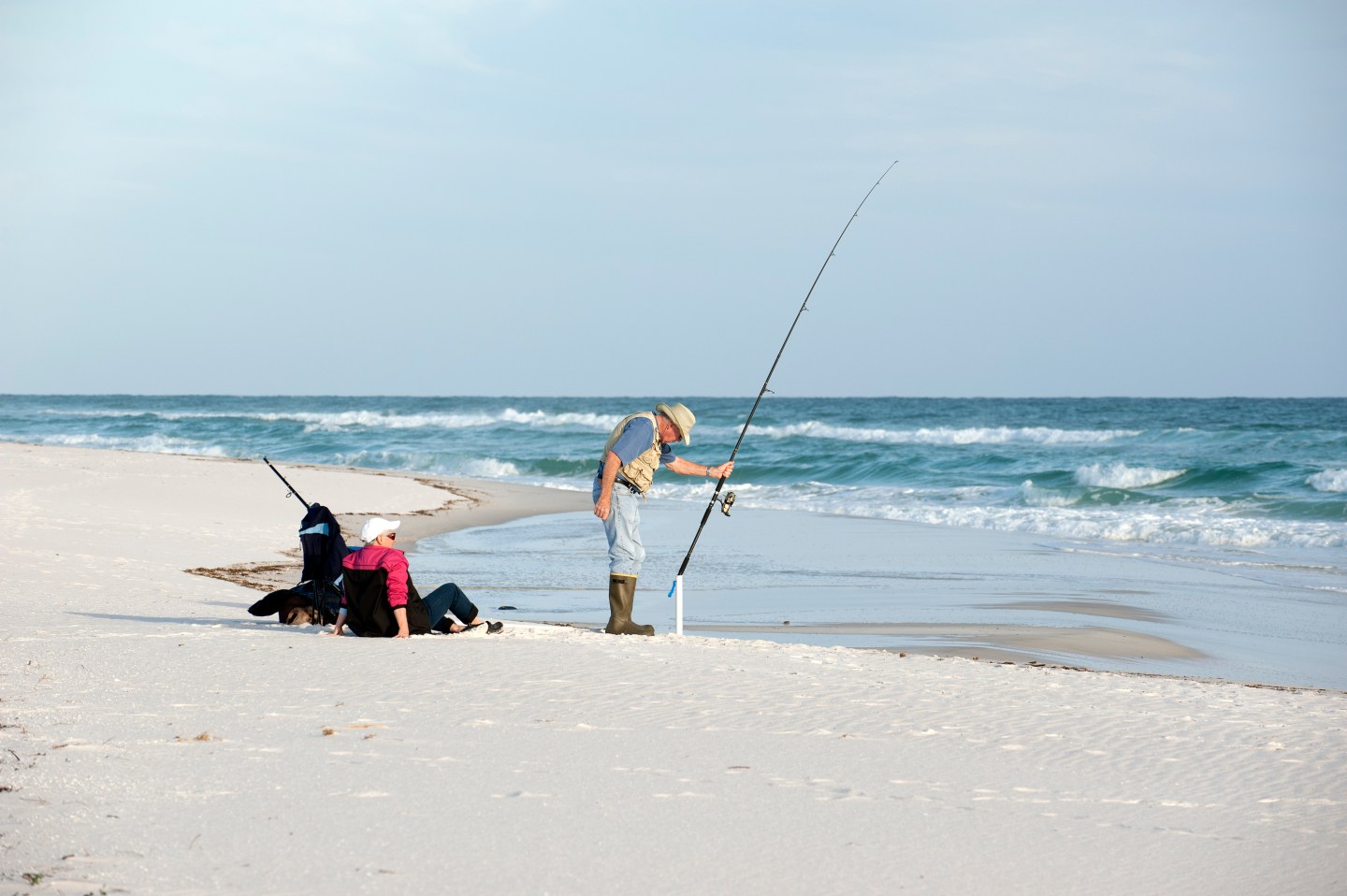 Elderly man fishing Gulf Coast Florida USA.
