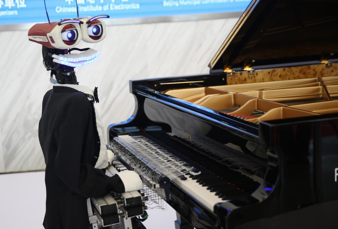 A robot pianist performs at the World Robot Conference