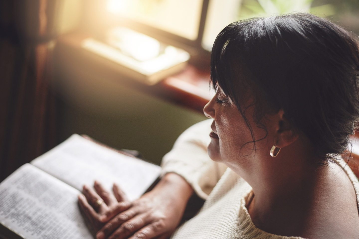 Black woman reading the Bible at home