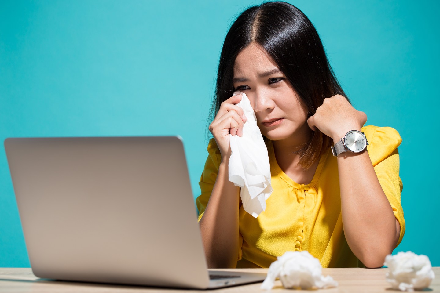 Woman looking so sad and crying at work.