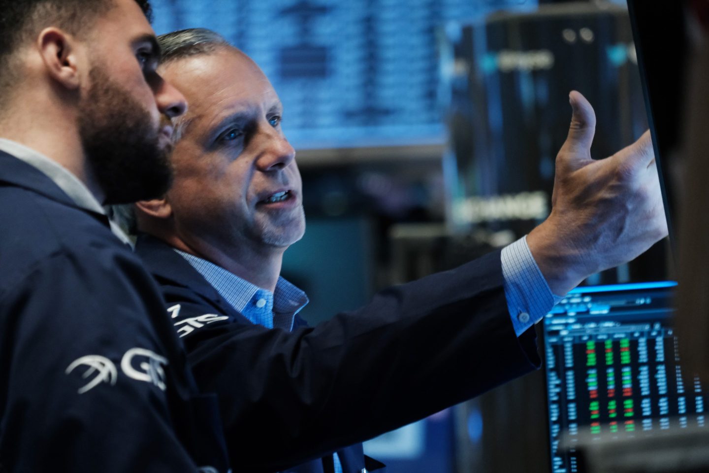 NYSE Traders discuss market movements on June 27, 2022.