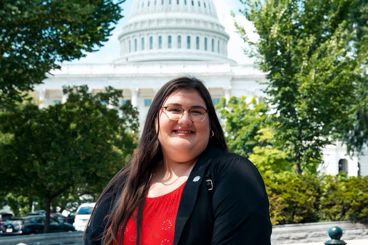 Portrait of Olivia Julianna outside the Capitol building.