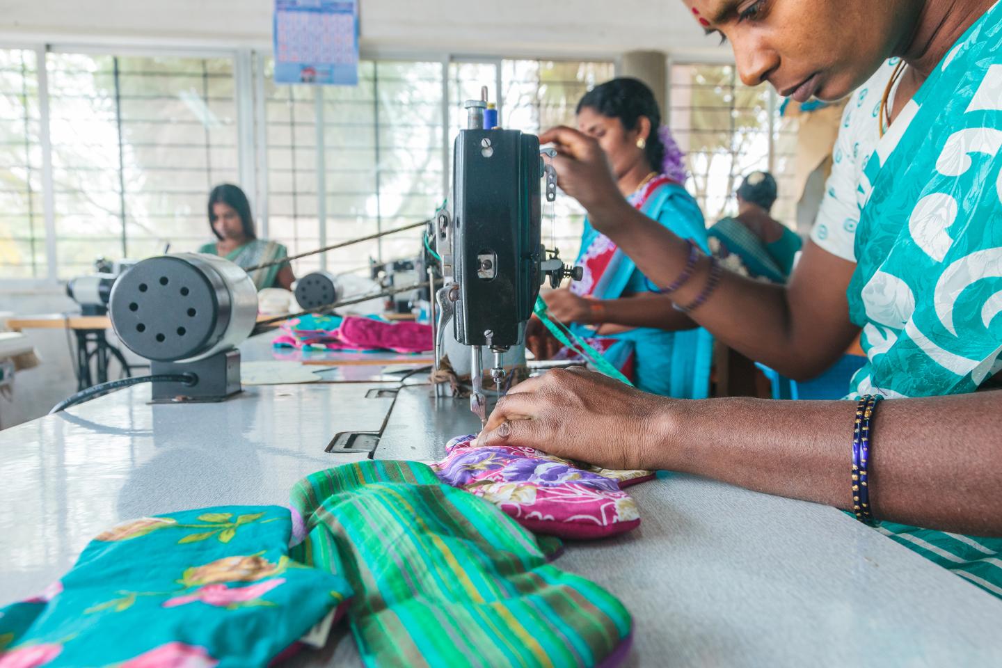 A woman sews Eco Femme's reusable cloth pads.