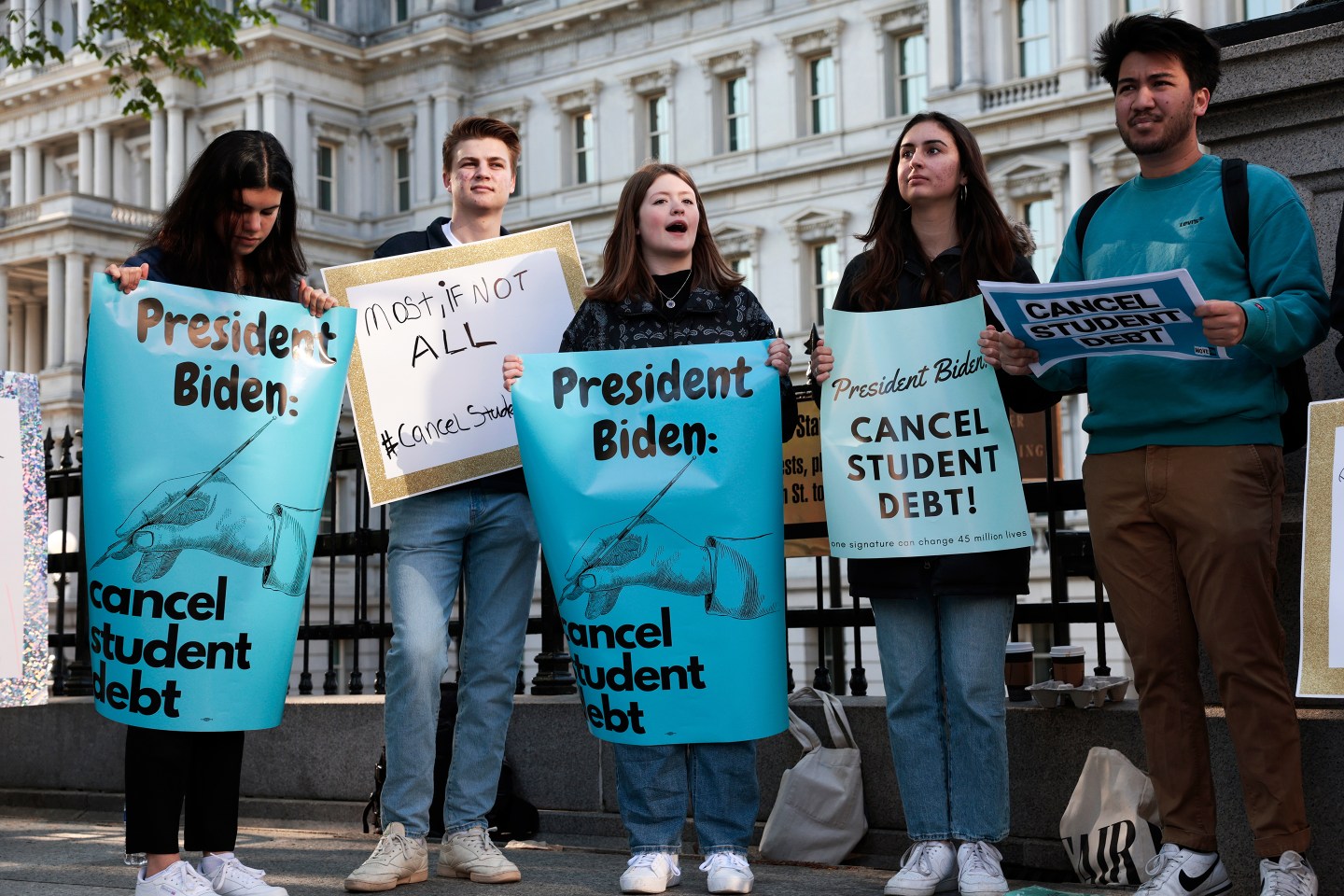ctivists hold signs as they attend a Student Loan Forgiveness rally on Pennsylvania Avenue and 17th street near the White House on April 27, 2022.