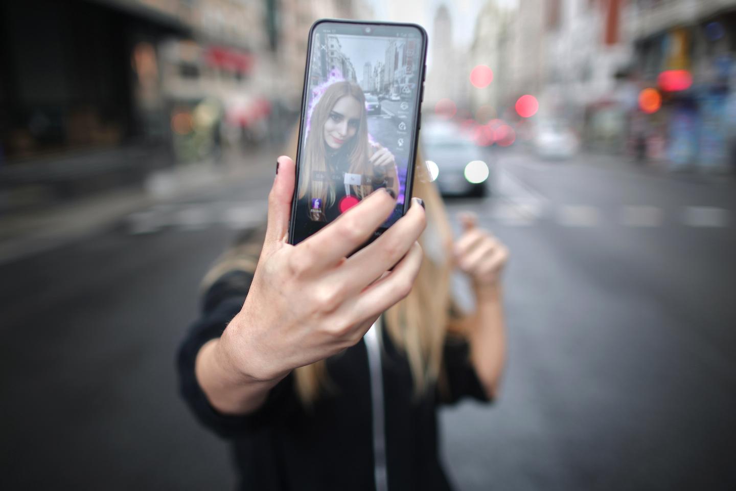 A girl uses Tik Tok.