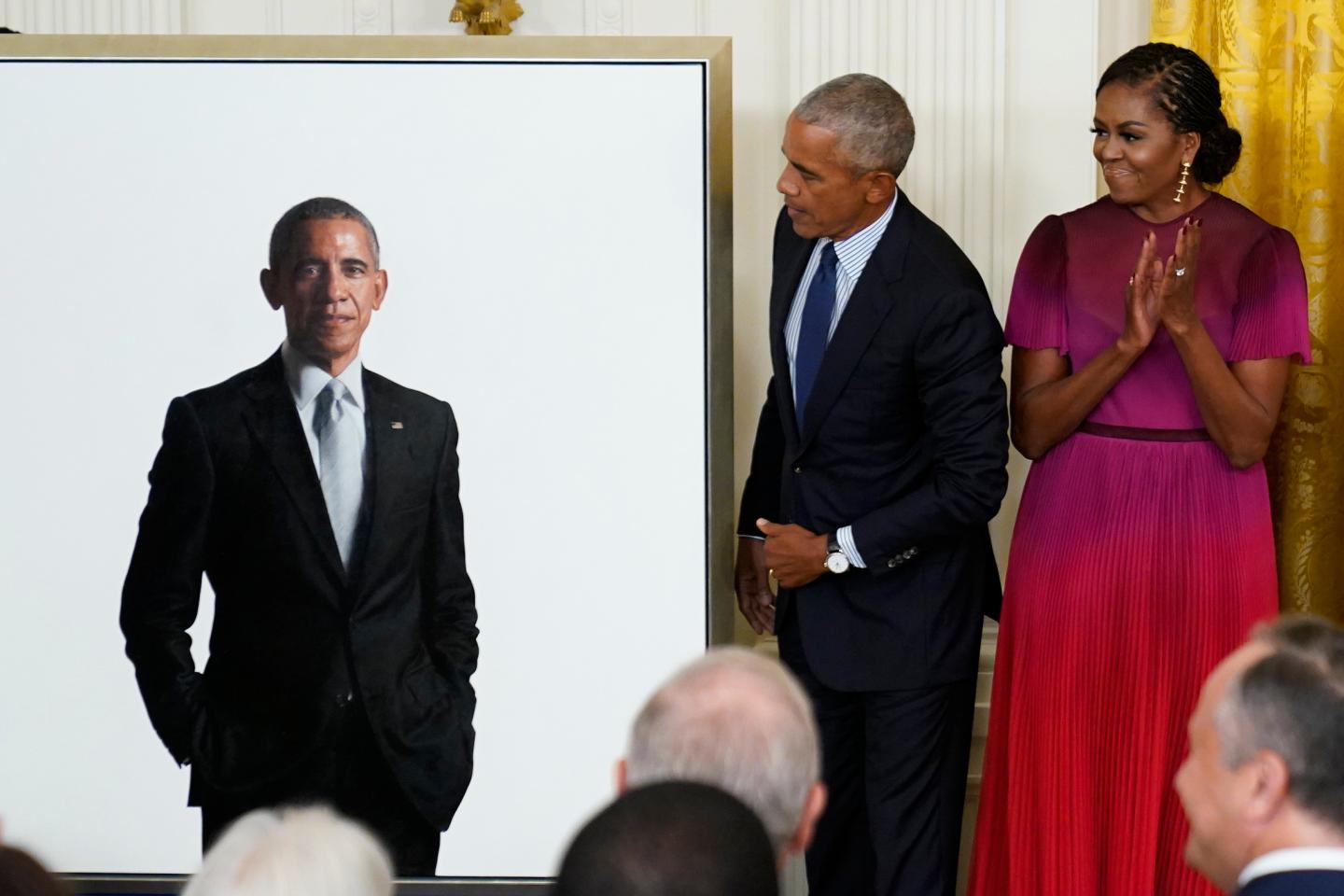Former President Barack Obama looks at his official White House portrait with former first lady Michelle Obama during a ceremony in the East Room of the White House on Sept. 7, 2022.
