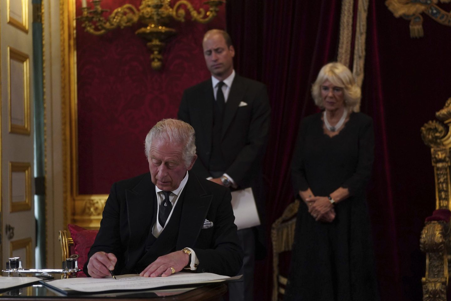 King Charles III signs an oath on Saturday at St James's Palace in London.