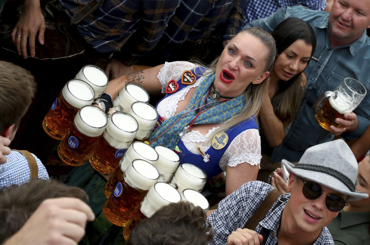 Waitress holds 12 glasses of beer