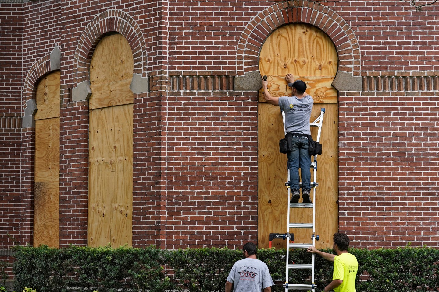 Workers board up university building