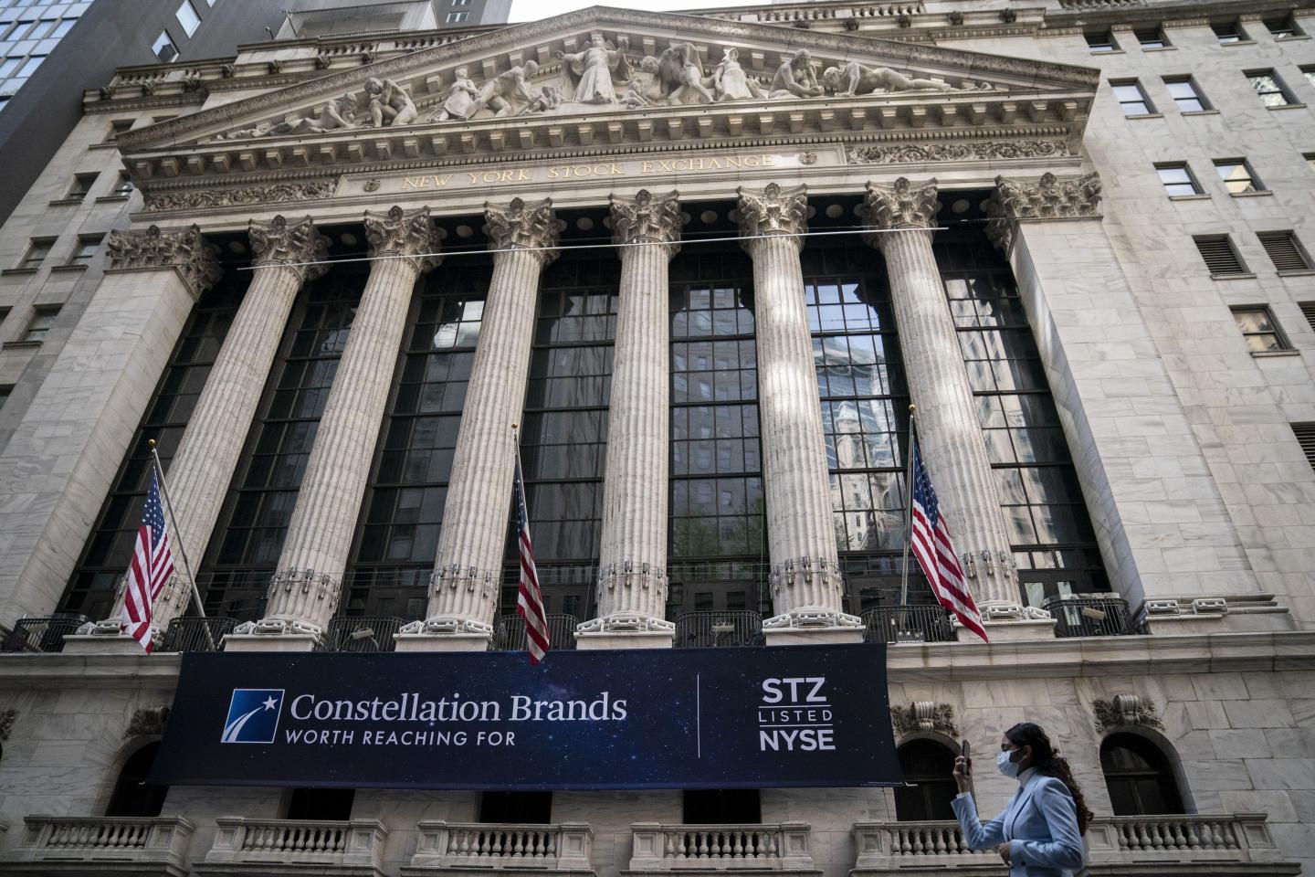 Pedestrians pass the New York Stock Exchange
