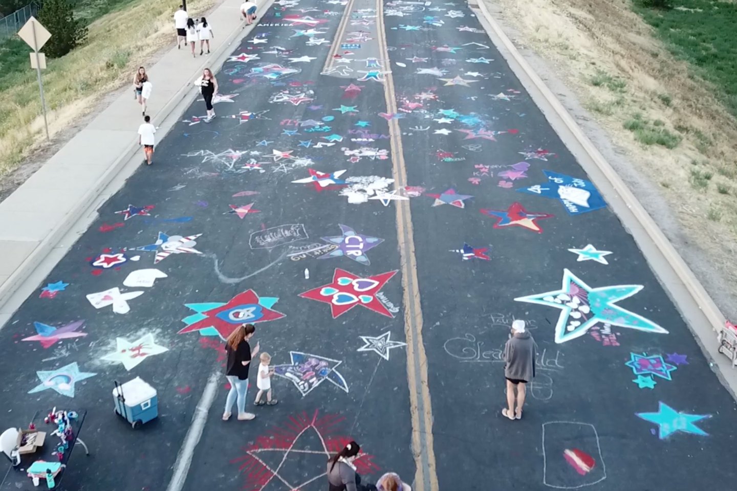 To help celebrate Independence Day, Clearfield residents gather annually to paint and decorate the Center Street Bridge blacktop in the week leading up to July 4.
famous event that brings a bunch of families together for a fun evening of painting the Center Street bridge for the 4th of July!