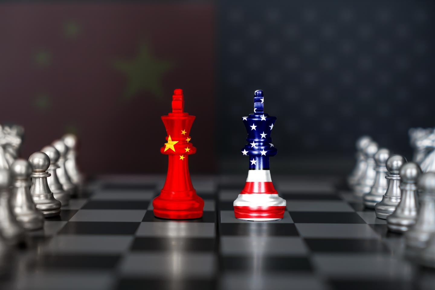 US America and China flags on chess king on a chessboard