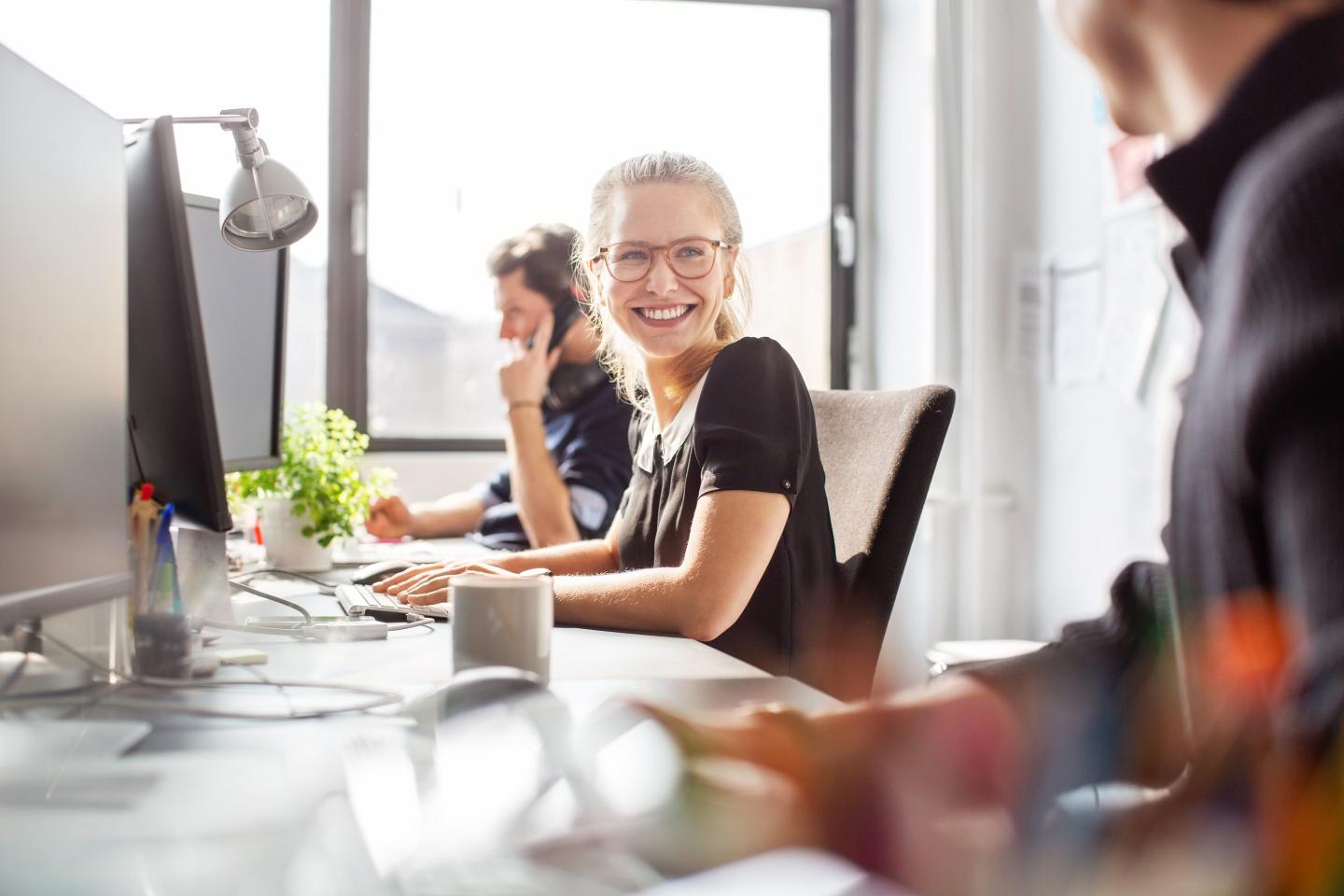 Woman smiling at desk