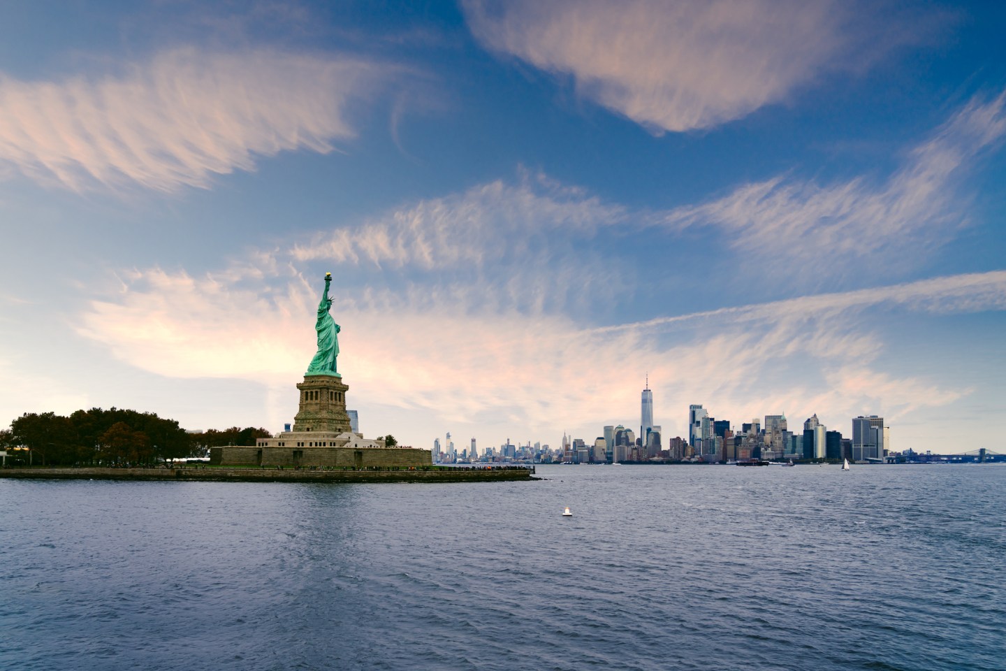 The statue of Liberty with World Trade Center background, landmarks of New York City.