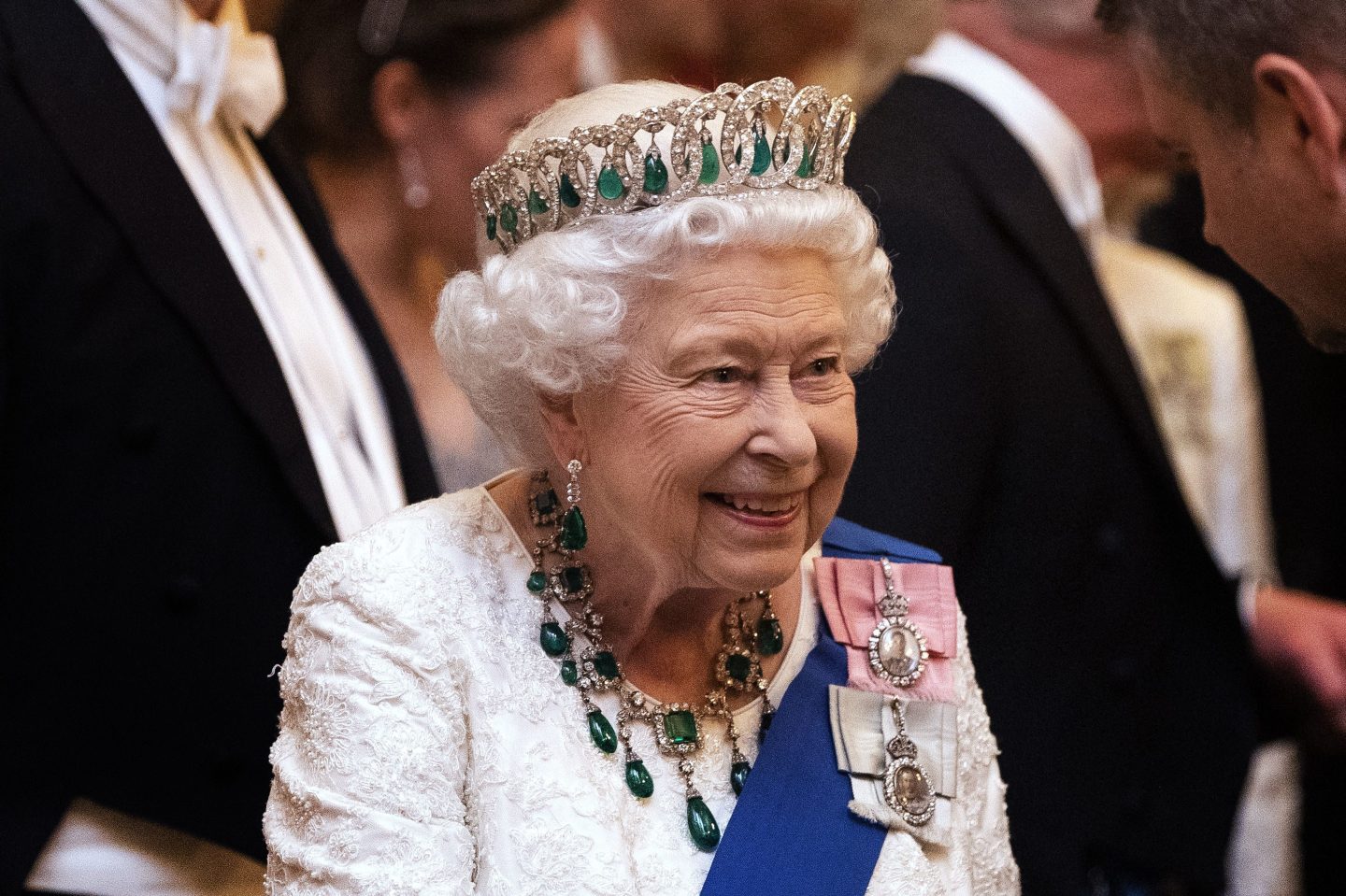 Queen Elizabeth II talks to guests at an evening reception