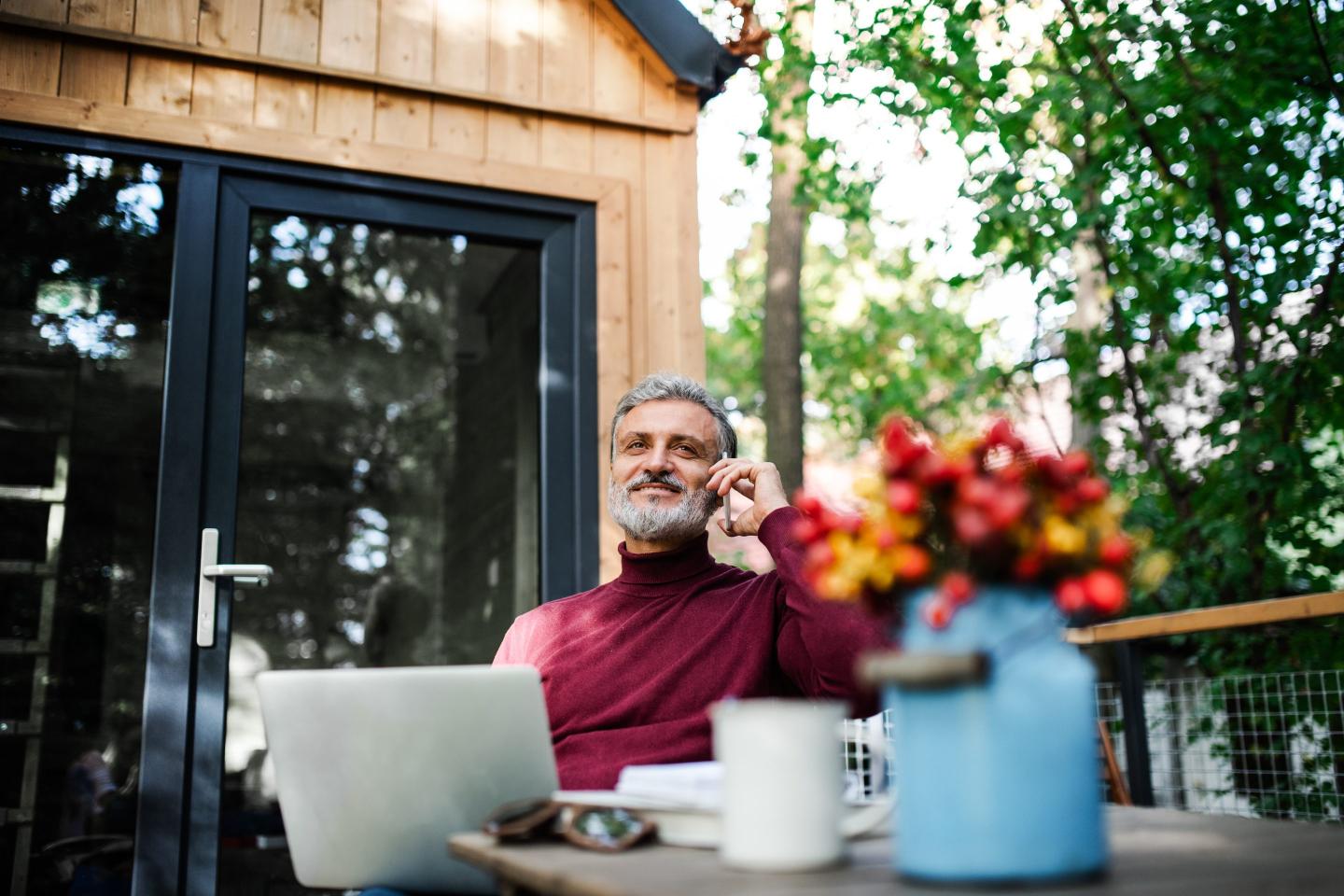 man on porch with laptop