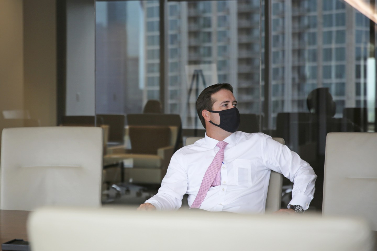 An employee wears a protective mask at an office in Dallas.