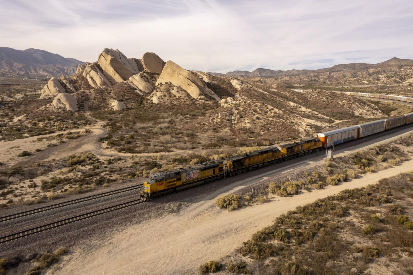 A freight train passes a mountain in California