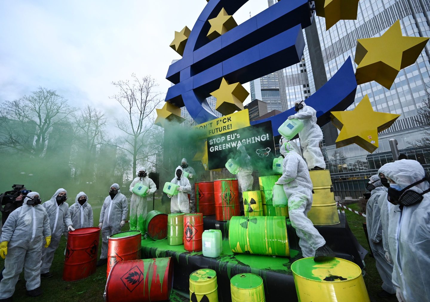 11 January 2022, Hessen, Frankfurt/Main: Activists of the "Koala Kollektiv" demonstrate in front of the Euro sculpture in downtown Frankfurt against greenwashing of nuclear energy and natural gas by the taxonomy of the EU.