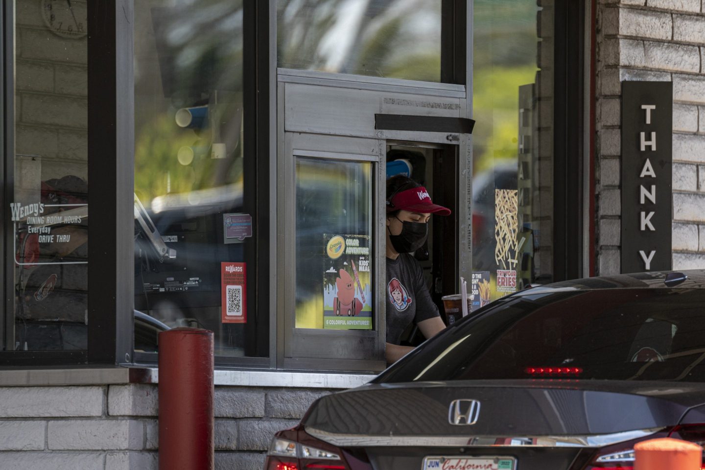A worker in the drive-thru of a Wendy’s in Pinole, Calif.