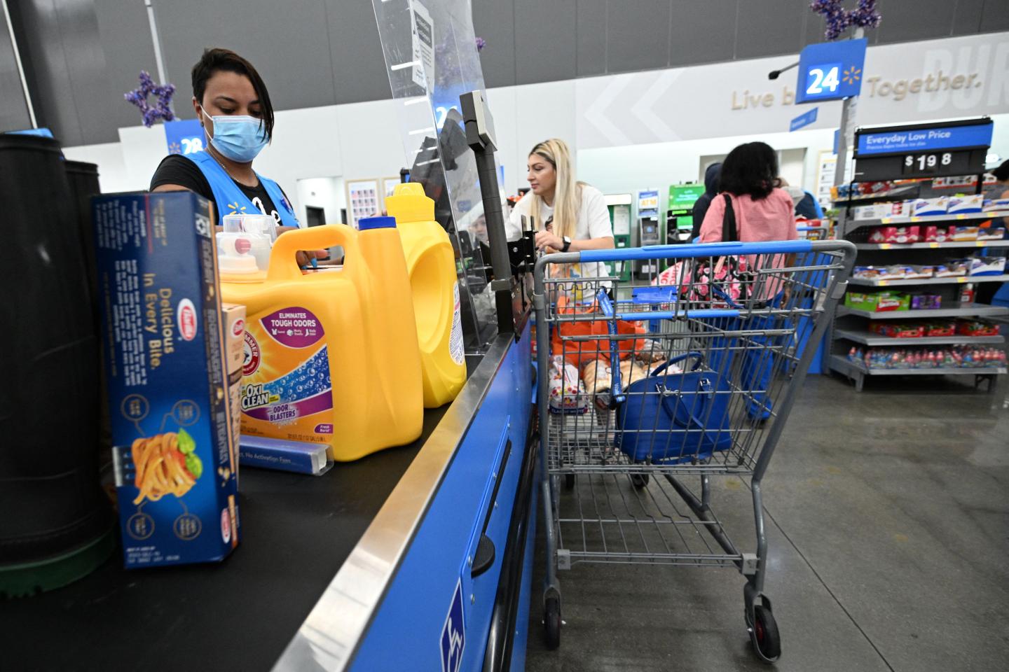 A cashier scans items at a Walmart store in Burbank, California on August 15, 2022.