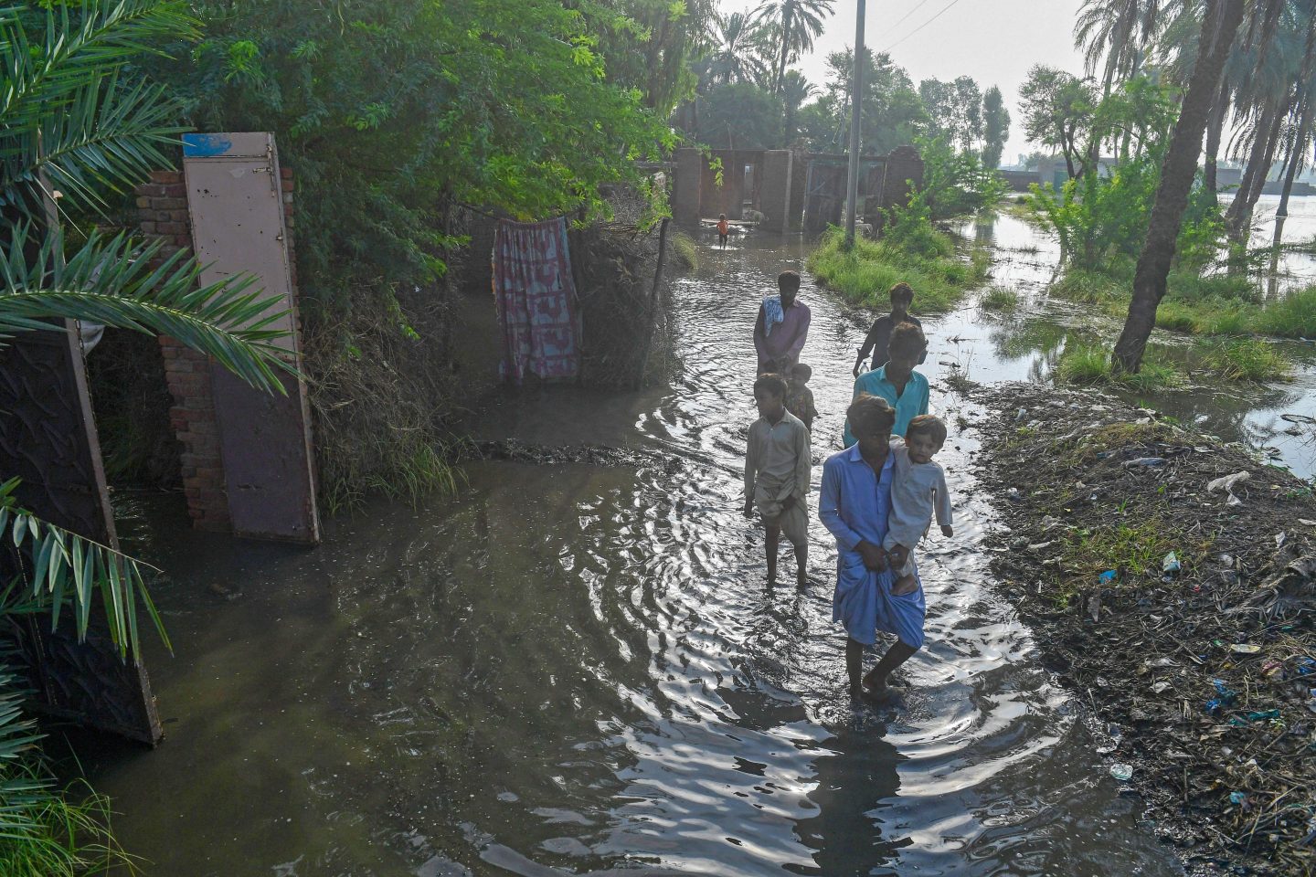 Residents wade through a flooded street in Sukkur, Sindh province in Pakistan on September 2nd.