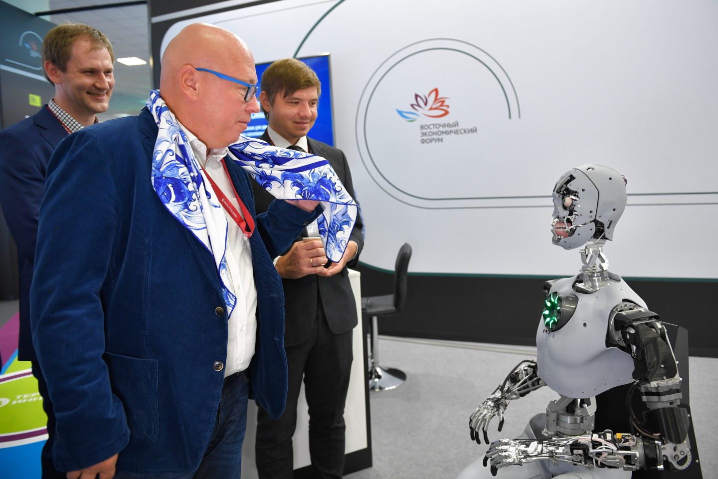 People interact with a talking robot during the 7th Eastern Economic Forum EEF in Vladivostok, Russia, on Sept. 5, 2022. Restrictions on access to western technology may push Russia a generation or two behind current standards as it’s forced to rely on less advanced alternatives from China and Southeast Asia.