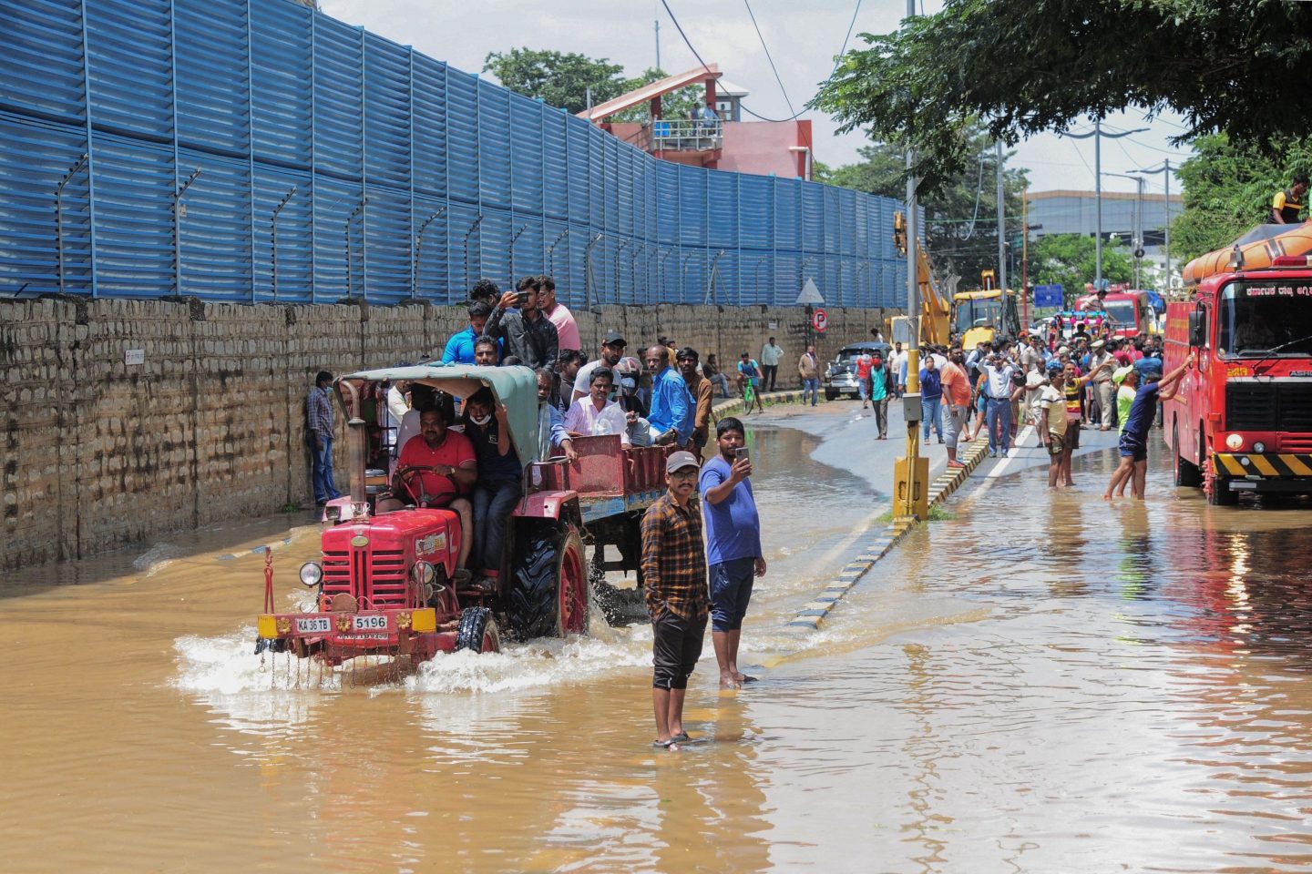 Commuters are ferried in a tractor through a waterlogged street after heavy rains in Bangalore on Sept. 6, 2022.