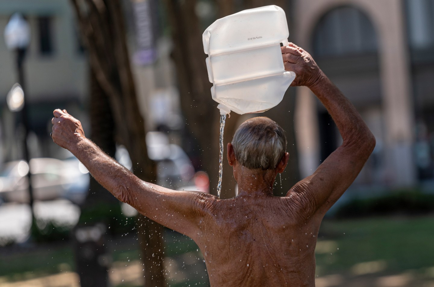 A resident cools off with a bottle of water during a heatwave in Sacramento, California, US, on Tuesday, Sept. 6, 2022.