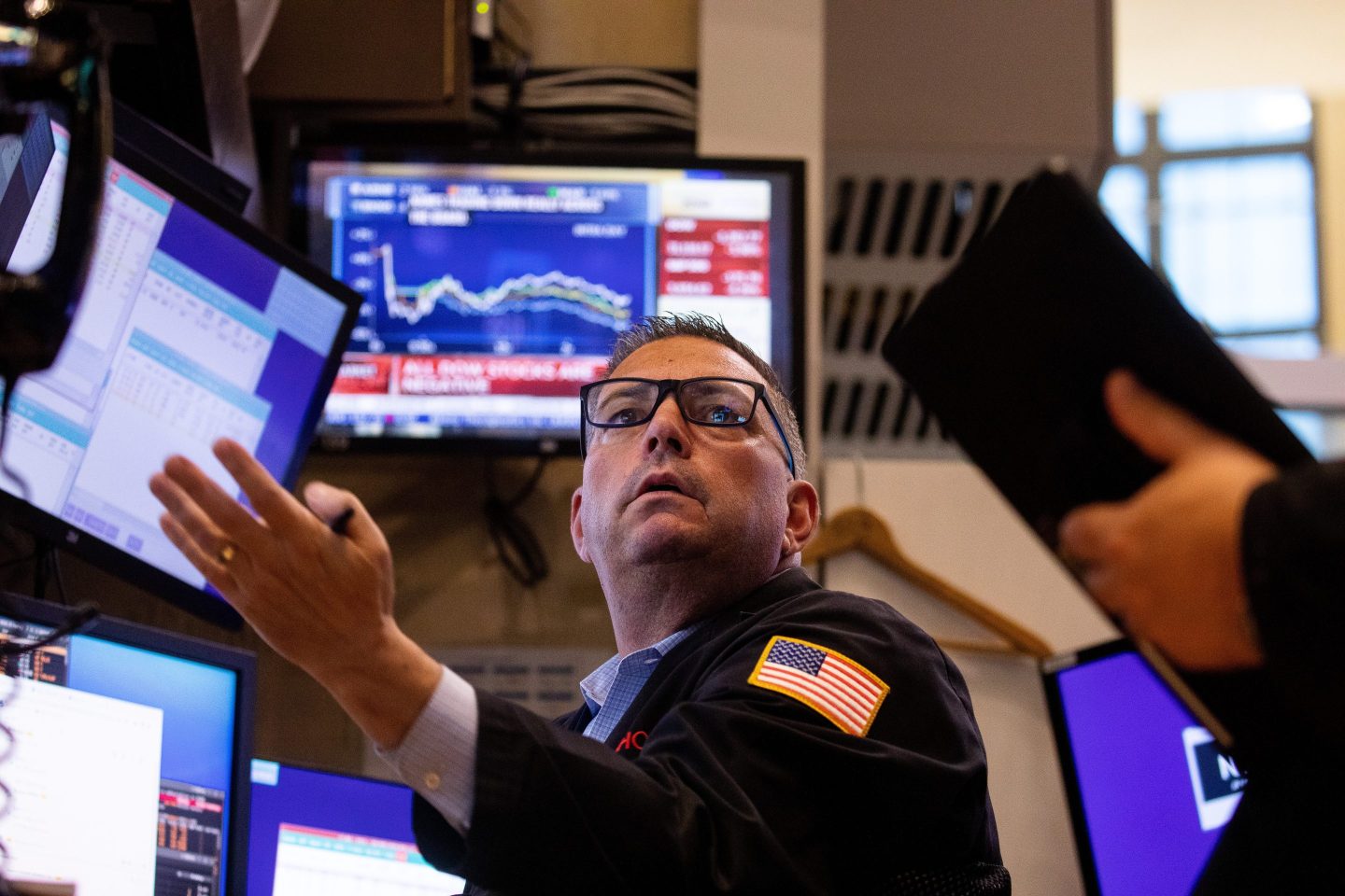 A trader at the New York Stock Exchange looks disgruntled.