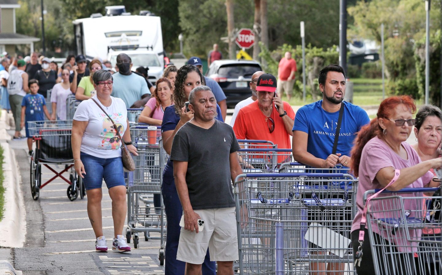 Shoppers line up outside a store