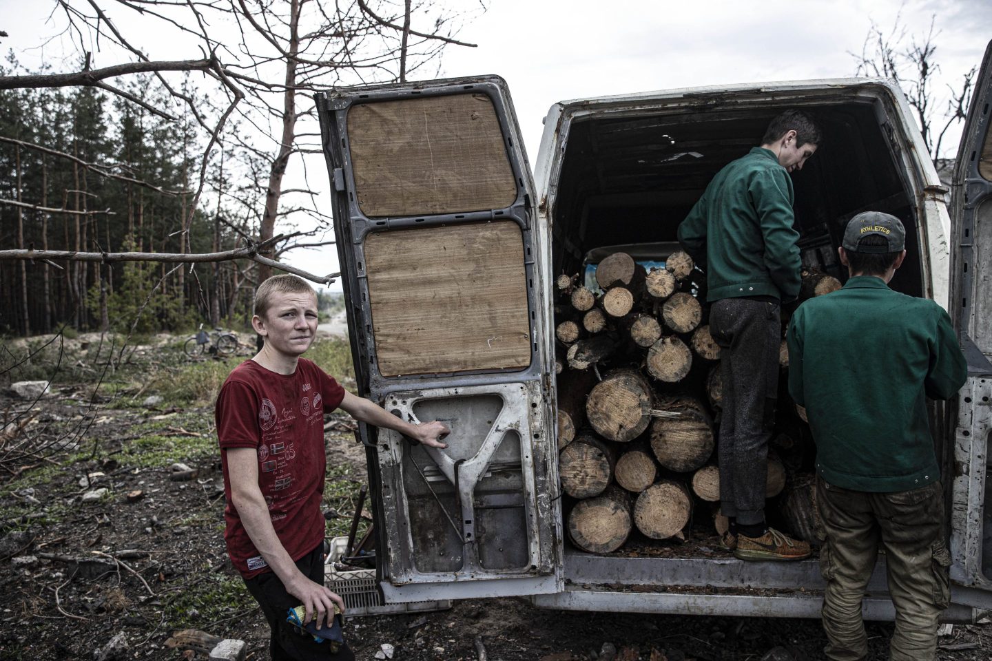 Men load wood into a truck in Ukraine.