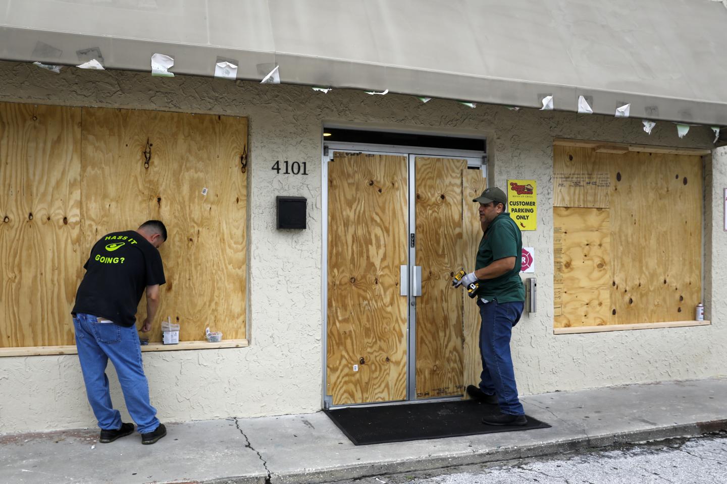 Workers board up a restaurant ahead of Hurricane Ian in Tampa, Florida, US, on Tuesday, Sept. 27, 2022. Ian made landfall over western Cuba as a major Category 3 hurricane, while churning toward Florida in what could be the worst storm to hit Tampa in over a century.