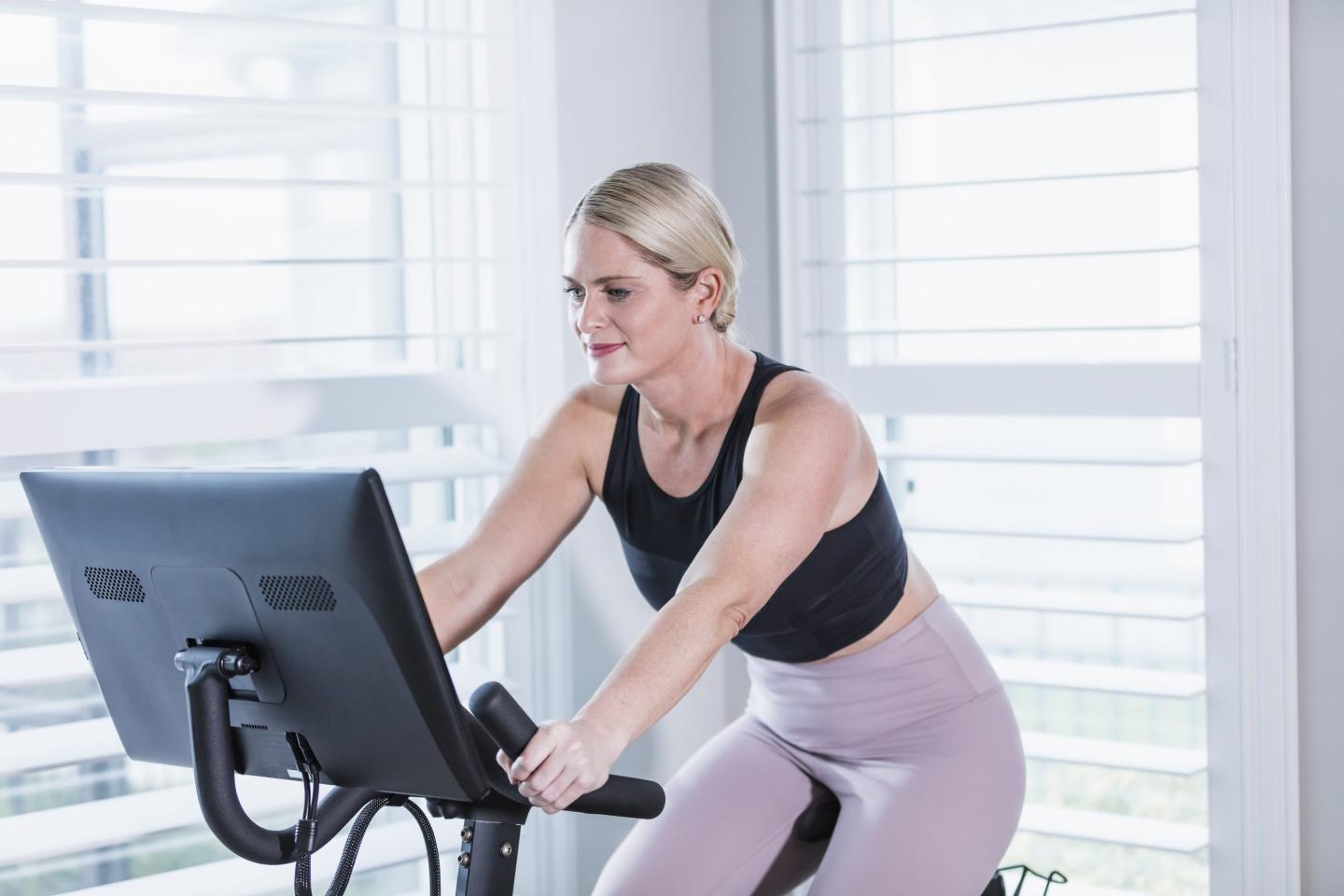 Woman riding a Peloton