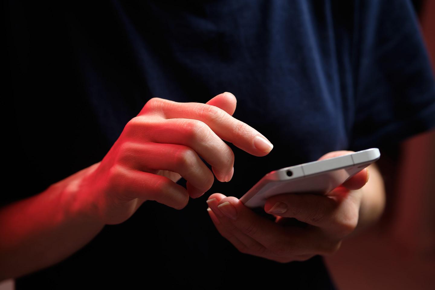 A mobile phone in the hands of a girl.