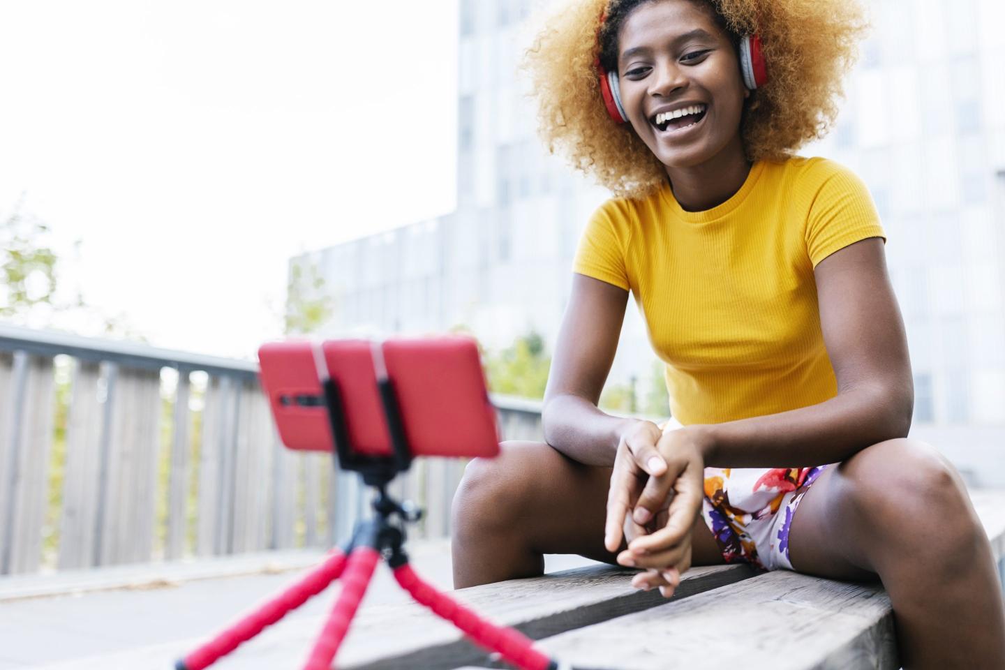 Gen Z content creator records content on mobile phone.