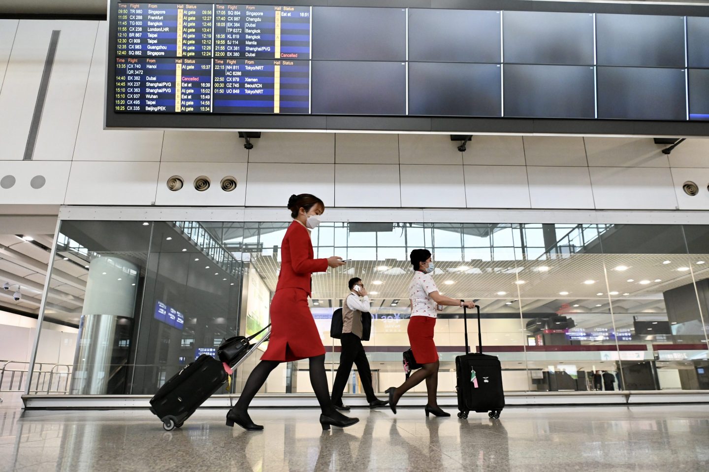 Flight attendants walk through the arrival hall of Hong Kong International Airport. Monkeypox has also arrived.