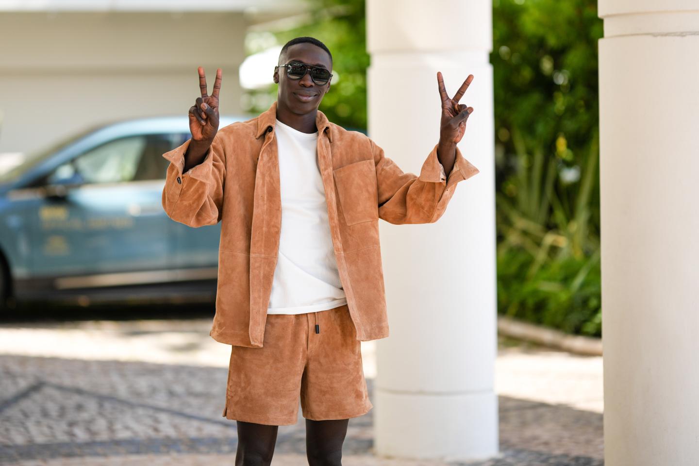 TikTok influencer Khaby Lame flashes the peace sign