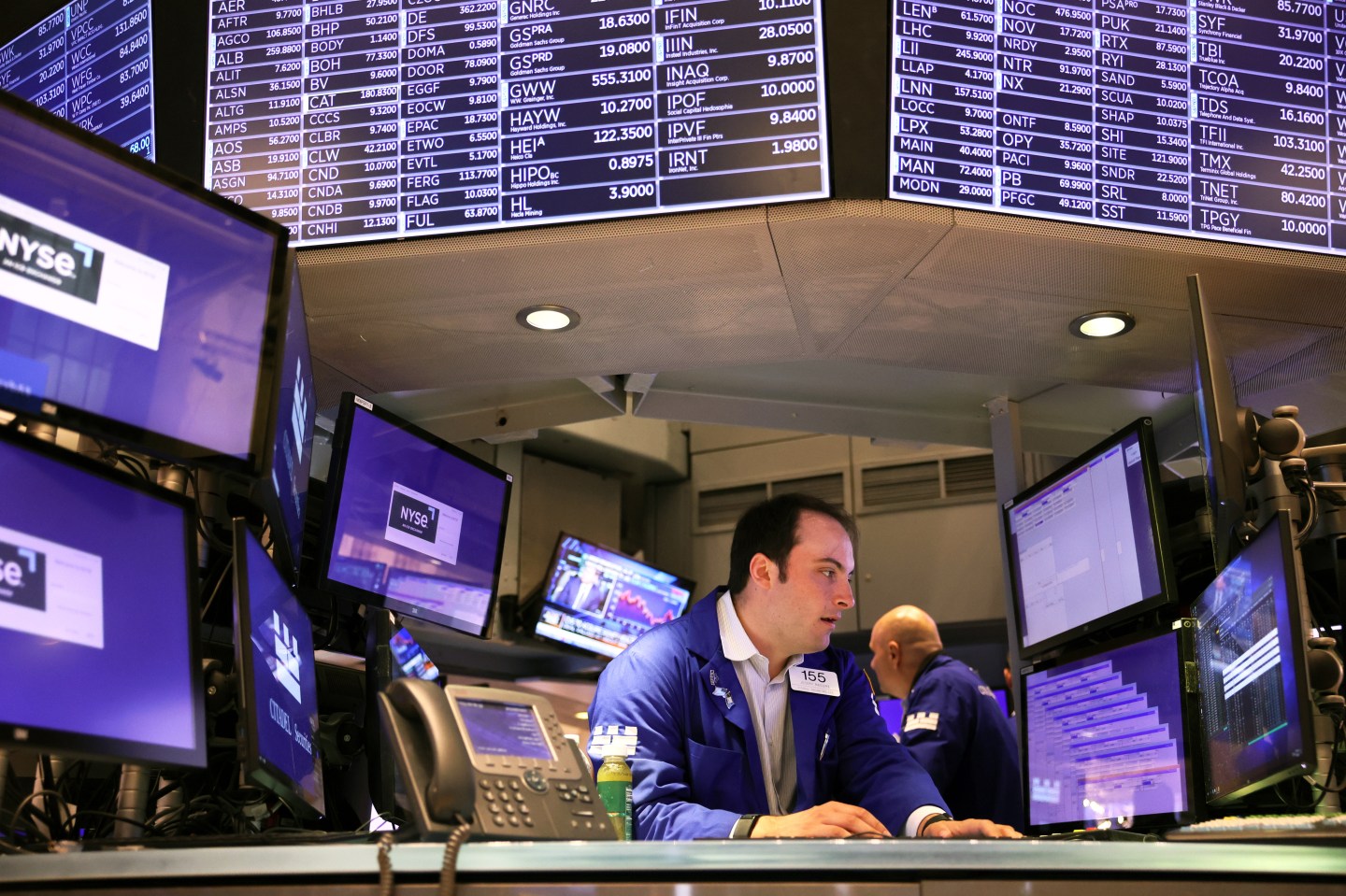 Traders work on the floor of the New York Stock Exchange during morning trading