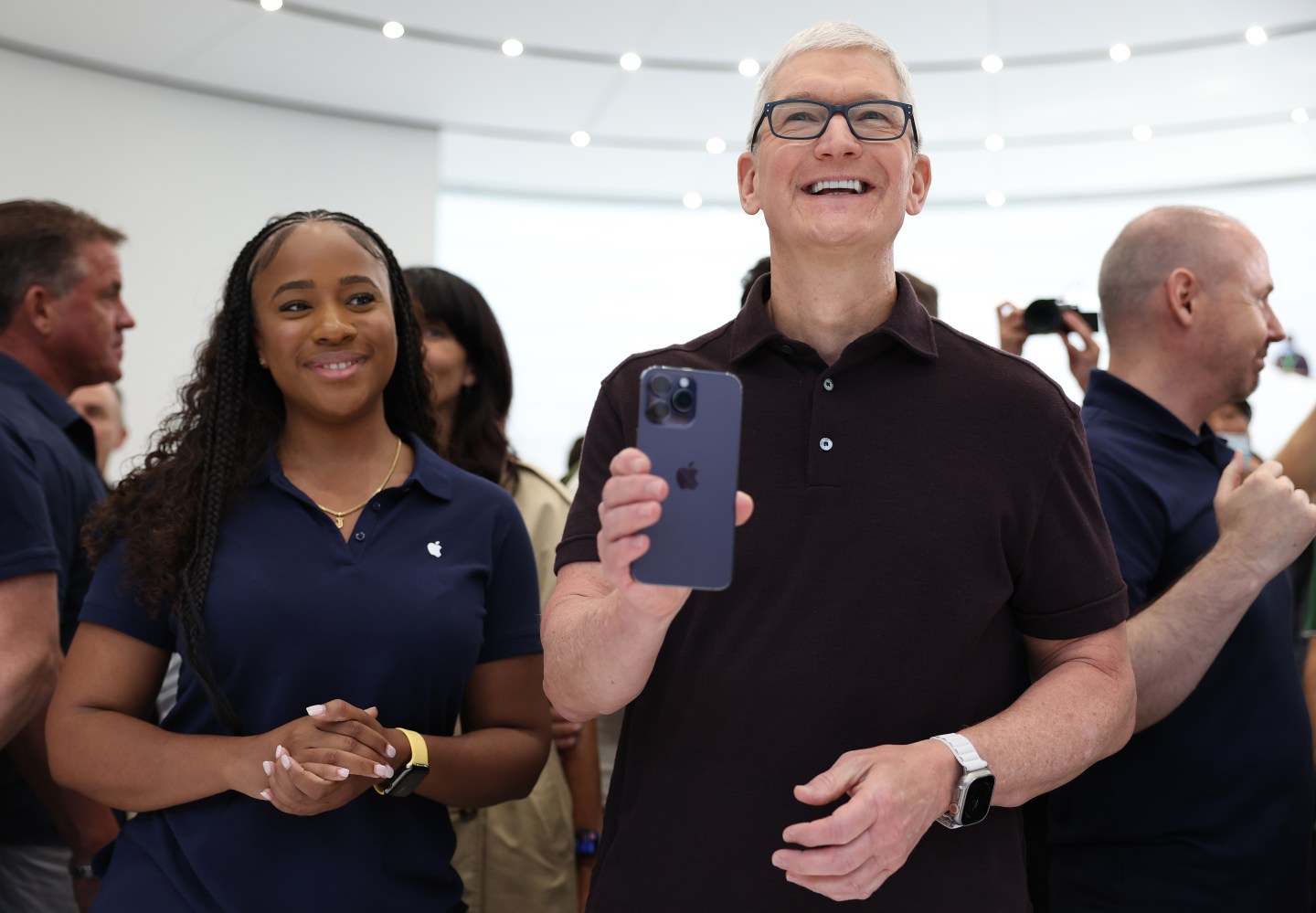 Apple CEO Tim Cook holds an iPhone 14 Pro