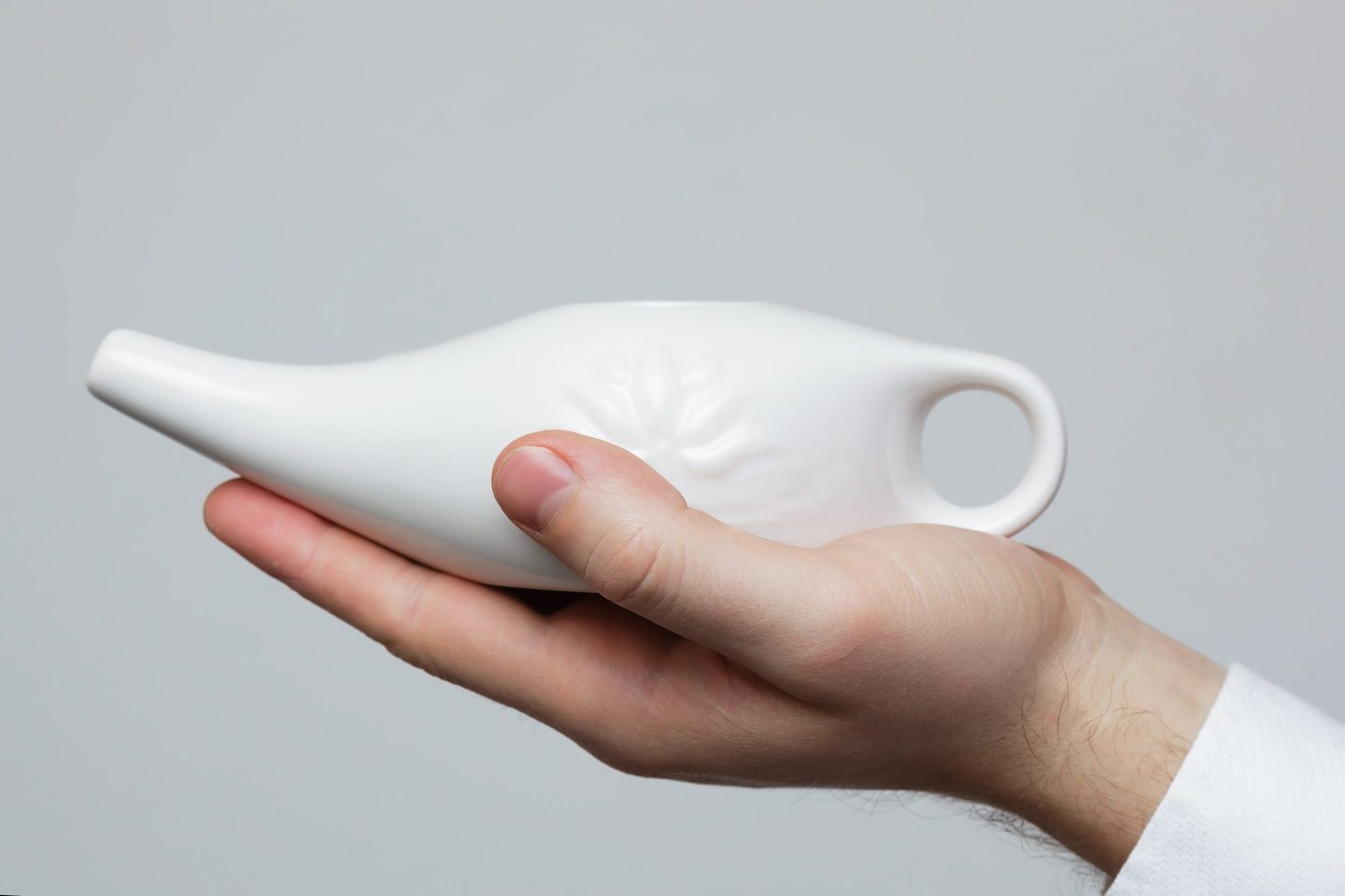 Person holding a Neti pot