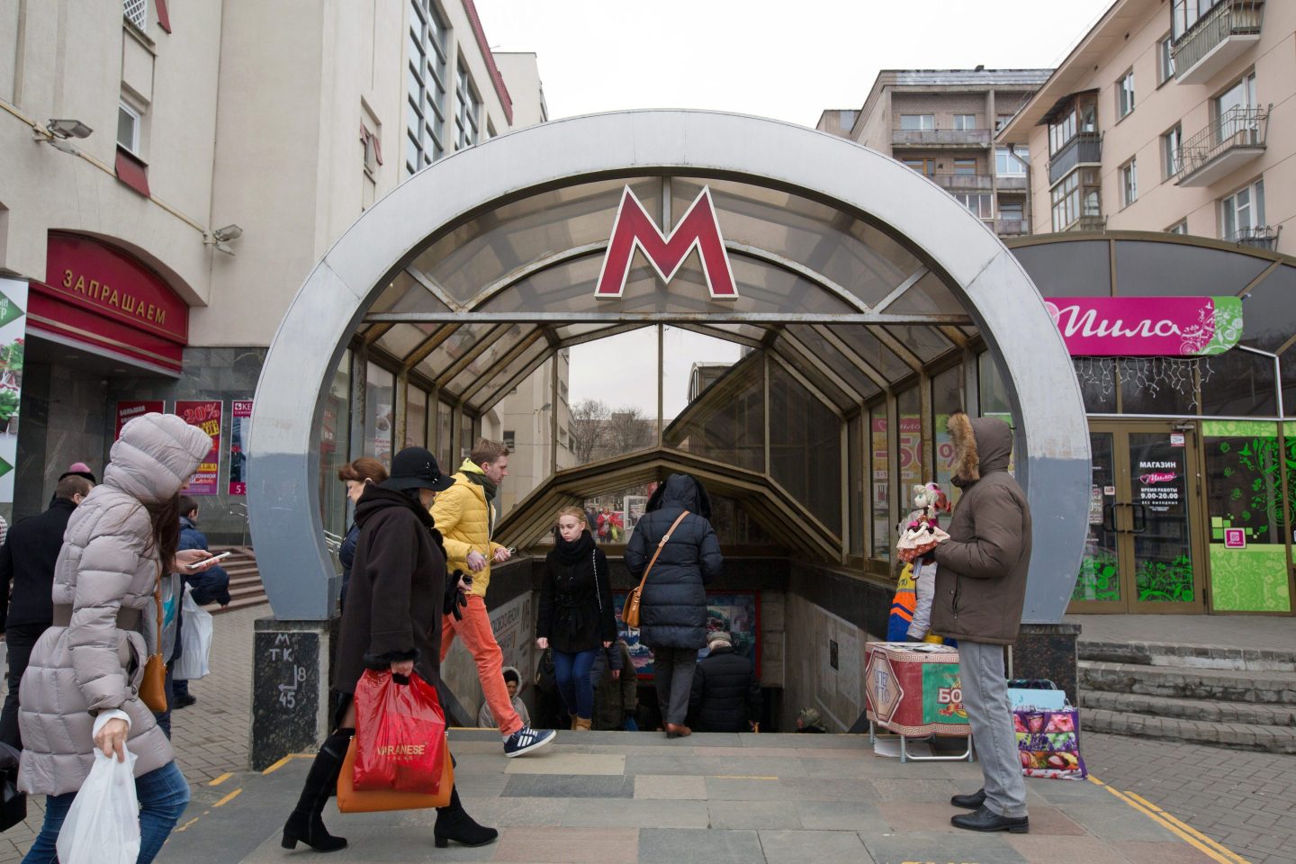 Shoppers pass an entrance to the Ploscha Yakuba Kolasa metro station in Minsk, Belarus, on Wednesday, March 16, 2016.
