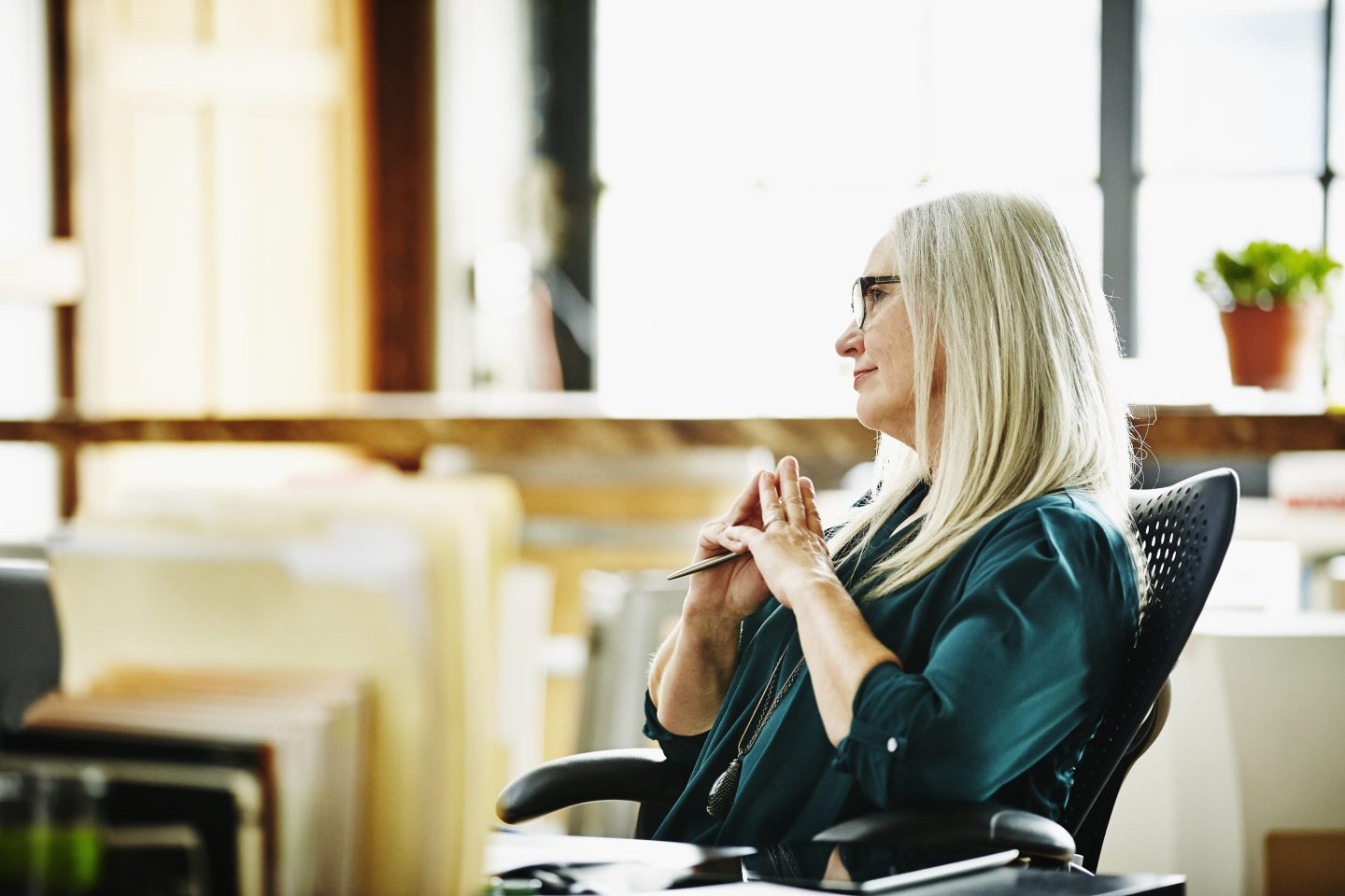 woman sitting in office chair at meeting